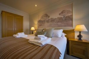 a bedroom with two beds with towels on them at Wilding Hotel in Brough