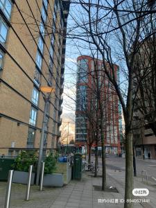 a city street with tall buildings and a street light at North Acton Flat in London