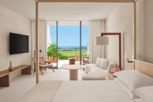 a hotel room with a bed and a tv at The Riviera Maya EDITION at Kanai in Playa del Carmen