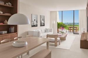 a living room with a couch and a table at The Riviera Maya EDITION at Kanai in Playa del Carmen