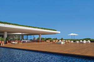 a resort with a swimming pool next to a resort at The Riviera Maya EDITION at Kanai in Playa del Carmen
