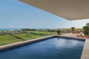 a swimming pool in the middle of a house at The Riviera Maya EDITION at Kanai in Playa del Carmen