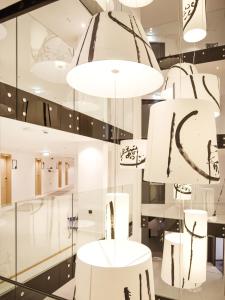 a store with white tables and chandeliers at Hotel Kompas in Dubrovnik