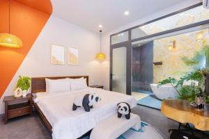 a bedroom with a large bed with panda and panda at Wabi Sabi Villa * Hồ Bơi Thác Nước 140 m2 * Phòng Karaoke Thủy Cung in Vung Tau