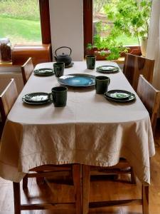 a table with plates and cups on top of it at Wyciszek - mazurska agroturystyka in Węgorzewo