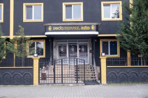 a black and yellow building with the front door at Veda Royal Suite in Duzce