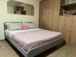 a bedroom with a bed with a wooden cabinet at MareLuna Guest House in Naples