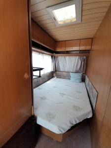 a small bed in the back of an rv at Kamping, trailer Molly in Ulcinj