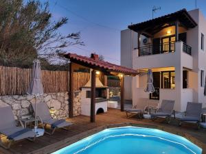 a villa with a swimming pool and a house at Anelia Serene Villa in Sfakaki