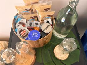 a table with a basket of food and a bottle at Pura Vida Apartment in Catania