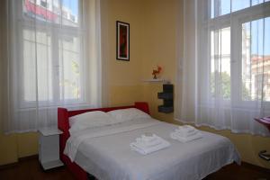 a bedroom with a bed with two towels on it at Apartment King in Opatija