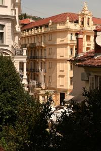 a group of buildings in a city with trees at Apartment King in Opatija