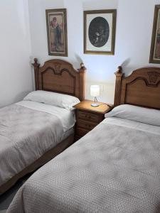 Posteľ alebo postele v izbe v ubytovaní Apartamentos Niña de Oro