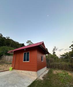 a small red house with a red roof at Maloop Cafe Bungalow in Koh Rong Island