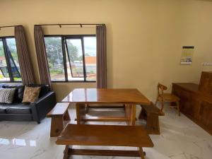 a living room with a table and a couch at RedDoorz Syariah near Alun Alun Purwokerto 3 in Purwokerto