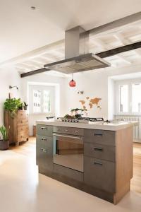 a kitchen with a stove top oven in a room at Idyllia - Cozy central retreat in Trastevere in Rome