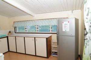 a kitchen with a refrigerator and a window at Gizo Lodge in Gizo