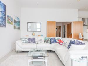 a white living room with a white couch at Bay Sea View in Torquay