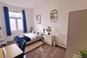 a bedroom with a bed and a desk and a window at 2 Bed Apartment, Near Canary Wharf, O2, Excel, Airport in London