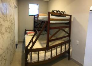 a couple of bunk beds in a room at Apartamento ao lado do beto carreiro in Penha