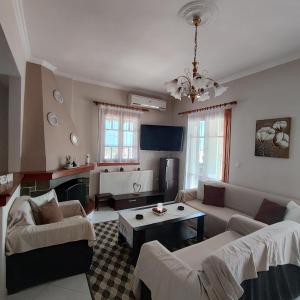 a living room with a couch and a table at Christina's house in Kipséli