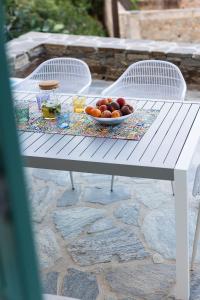 a white table with a bowl of fruit on it at The Architect's House, 3br villa in Naxos in Naxos Chora