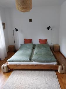 a bed with a wooden frame in a room at Wyciszek - mazurska agroturystyka in Węgorzewo