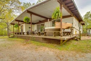 a house with a wrap around porch with a hammock at Elizabeth Vacation Rental with Private Hot Tub! in Elizabeth