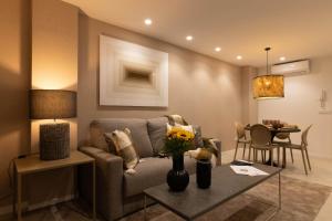 a living room with a couch and a table at Dorm4You Centro in Valencia