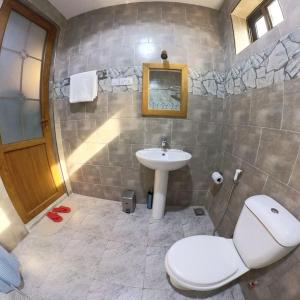 a bathroom with a toilet and a sink at Velmont Hotel in Dar es Salaam