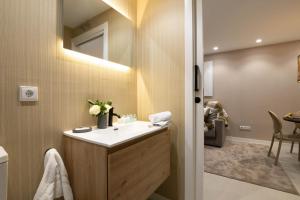 a bathroom with a sink and a mirror at Dorm4You Centro in Valencia +25 photos