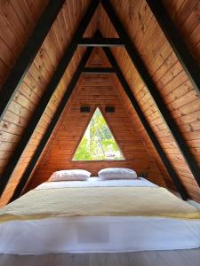 a bed in the middle of a room in a attic at Arsuz Yunus Otel Bungalow in Arsuz