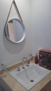 a bathroom sink with a mirror above it at BuenaVid By CafaYate ViP in Cafayate