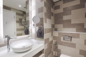 a bathroom with a sink and a mirror at Luxurious Studio at Palm Jumeirah in Dubai