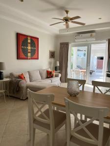 a living room with a table and a couch at VIEW TALAY VILLA POOL HOUSE 285 in Jomtien Beach