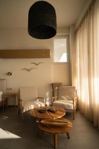 een woonkamer met 2 stoelen en een tafel bij ALS COMFORT SUITES in Preveza