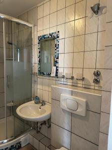 a bathroom with a sink and a mirror at Central Hotel in Offenbach