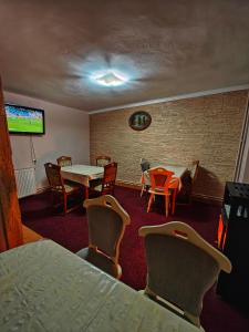 a conference room with tables and chairs and a tv at Casa Miclau in Băile Herculane
