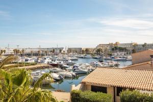 a marina with boats in the water and buildings at Cap Venus naturiste in Cap d'Agde