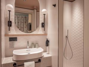 a bathroom with a sink and a mirror at Hotel Louison in Paris