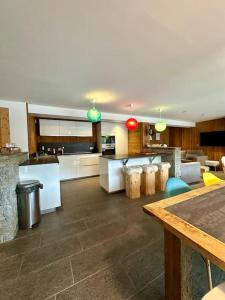 a large living room with a kitchen and a living room at Le refuge in Valloire