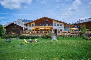 a large building with a lawn in front of it at Hotel Mohnenfluh in Lech am Arlberg +88 photos