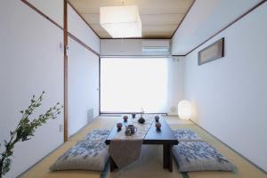 a living room with a table and two pillows at Mitao bld - 2 Bedroom Apt 4mins to PeacePark for 9ppl in Hiroshima