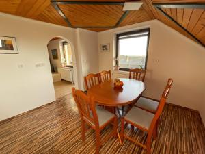 a dining room with a wooden table and chairs at Apartment Zupan in Preddvor