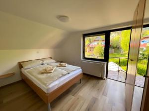 a bedroom with a bed and a large window at Apartment Zupan in Preddvor