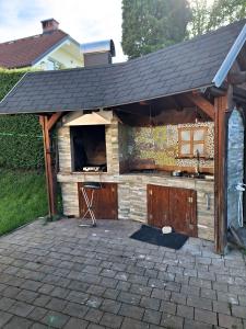an outdoor bar with a roof on a patio at Apartment Zupan in Preddvor +14 photos