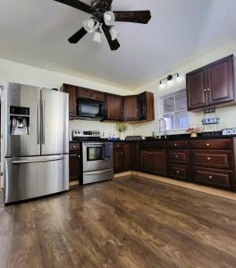 a kitchen with stainless steel appliances and a ceiling fan at A Princely Experience! in Stoughton