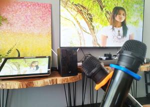 una scrivania con un microfono, un computer portatile e una televisione di D'Cove Villa Private Pool Kuantan a Kuantan Altre 44 foto