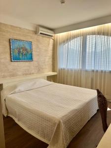 a bedroom with a large bed and a window at Oazis VIP Club in Sunny Beach
