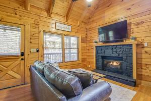 a living room with a couch and a fireplace at Pigeon Forge Vacation Rental with Private Hot Tub! in Pigeon Forge